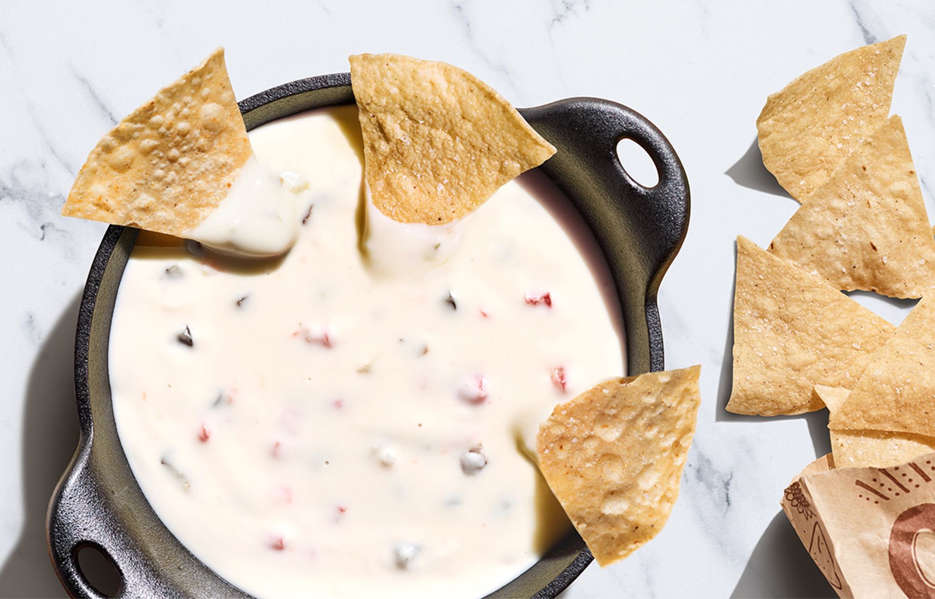 Four Days Only: Get a Free Topping of Queso Blanco with an In-app or Online Entree Purchase at Chipotle Four Days Only: Get a Free Topping of Queso Blanco with an In-app or Online Entree Purchase at Chipotle